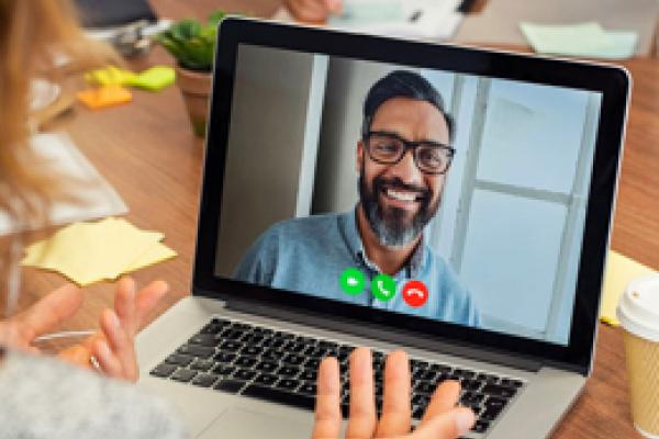 Person on a laptop diong a video conference call