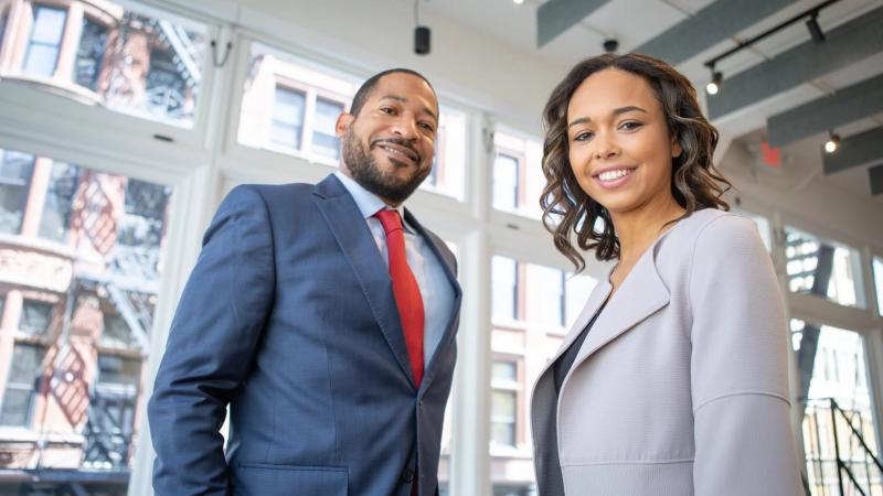 Two diverse executives standing in a office