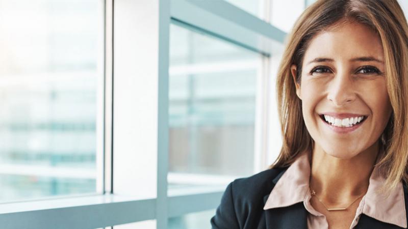 Female executive standing in front of a window