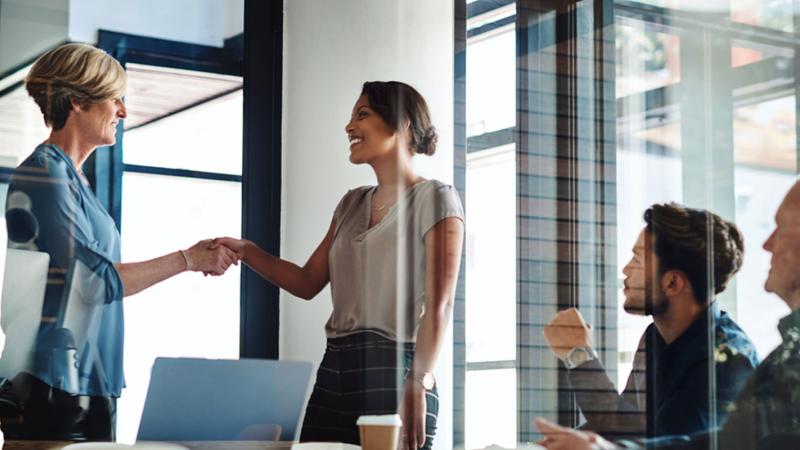 Group of people shaking hands in an office